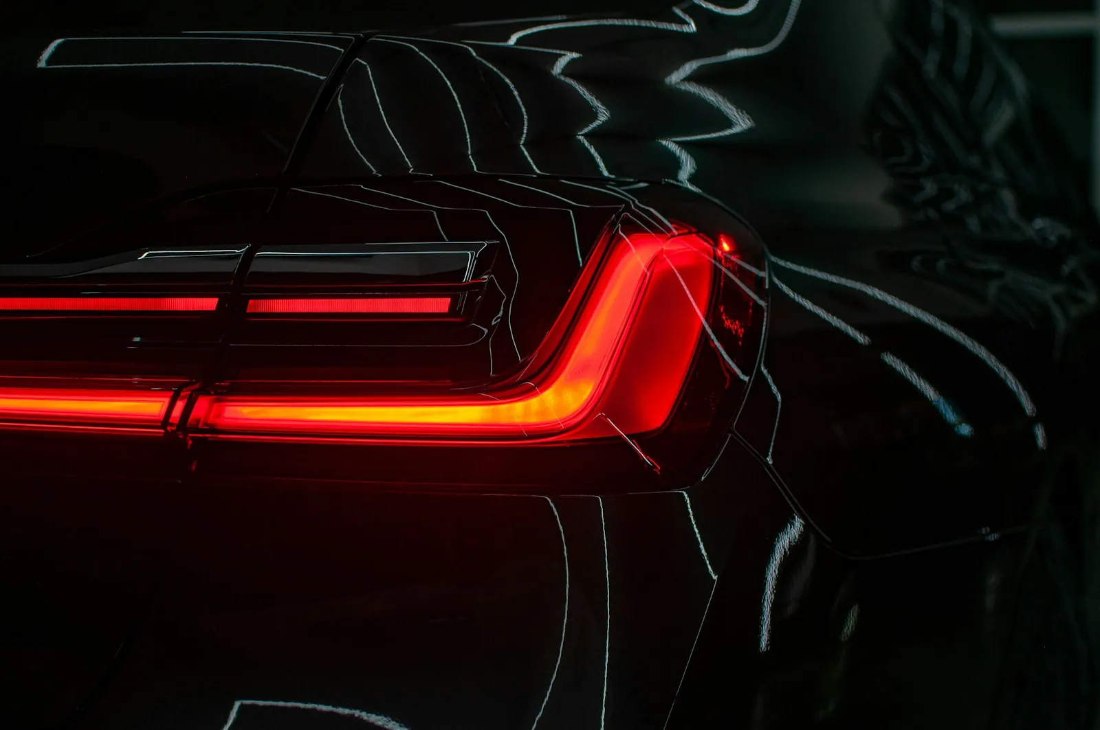 A driver checking a car's tail light before the drive test