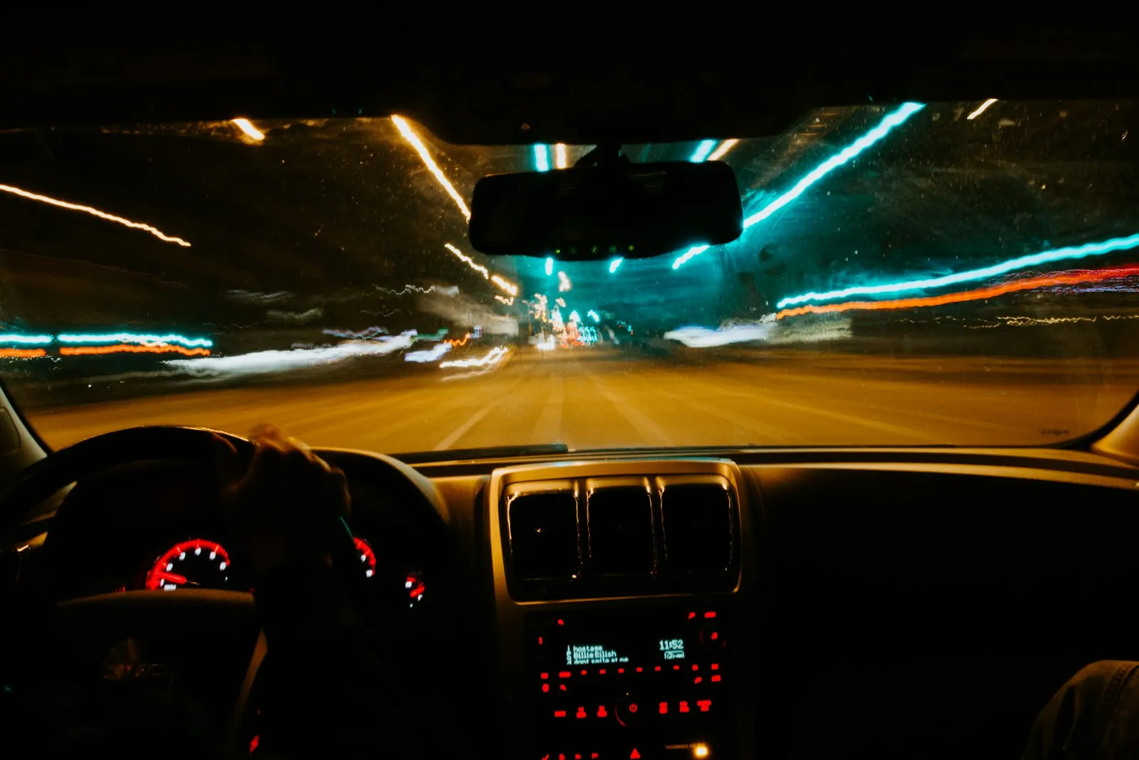A parent supervising a teen driver at night