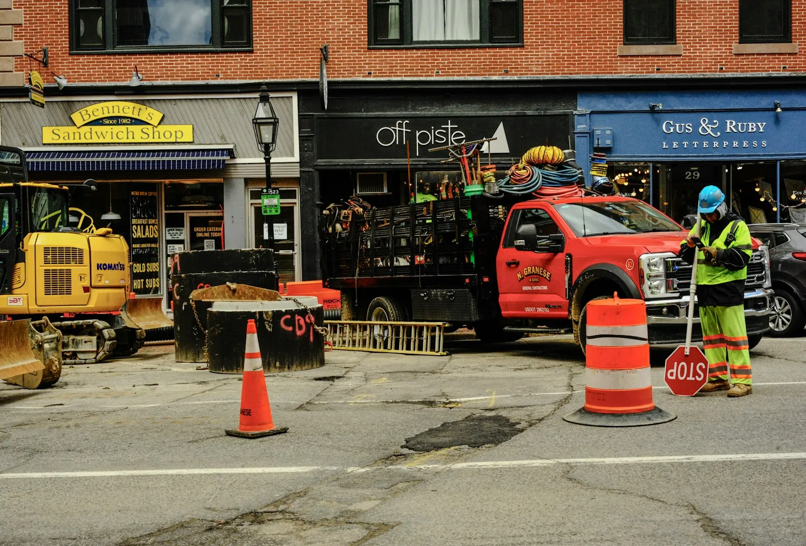 A road work zone with cones and a flagger
