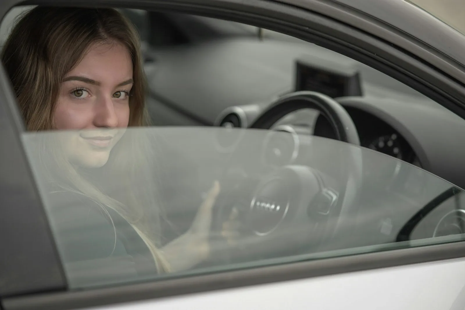 A driver turning to check the blind spot before changing lanes