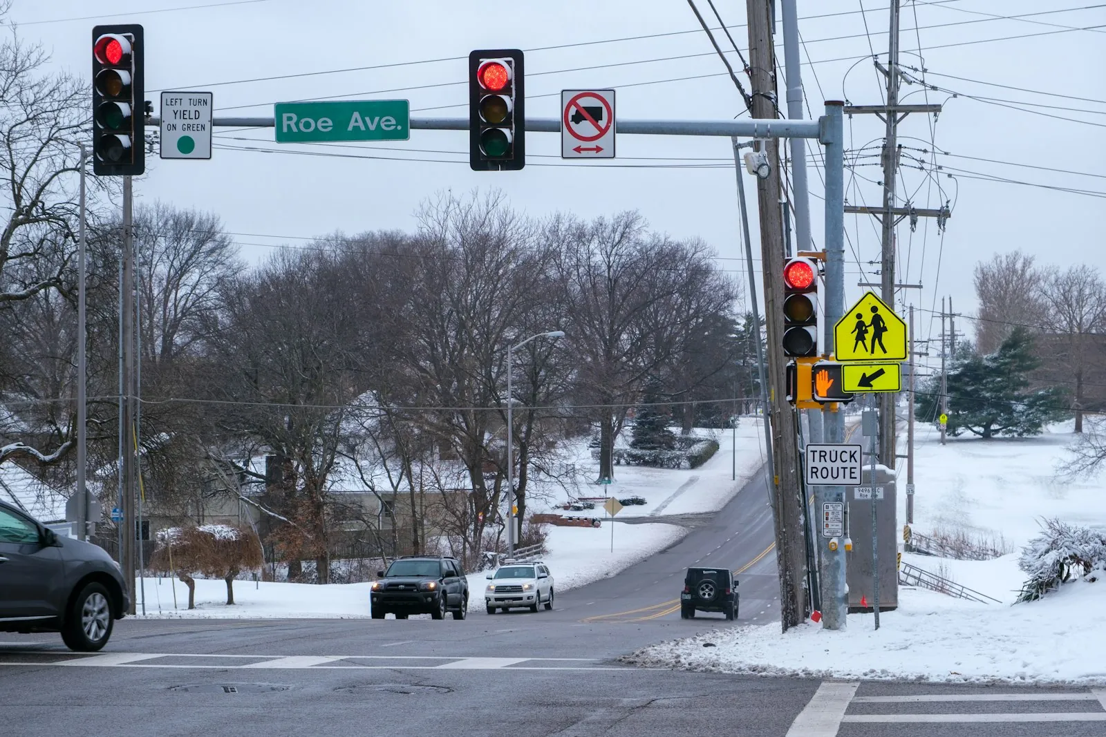 A car stopped behind the white stop line at an intersection